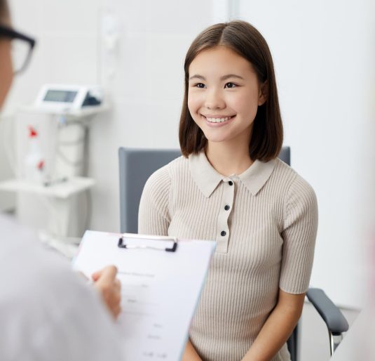 smiling-girl-in-doctors-office-QBNEG28.jpg